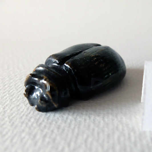 Handcrafted ceramic beetle figurine "The Obsidian Beetle (#4)" in stoneware by Nikolaj Jesper Cyon. Finished with a dark, glossy black and deep brownish glaze over a smooth rounded carapace with sculpted insect anatomy.